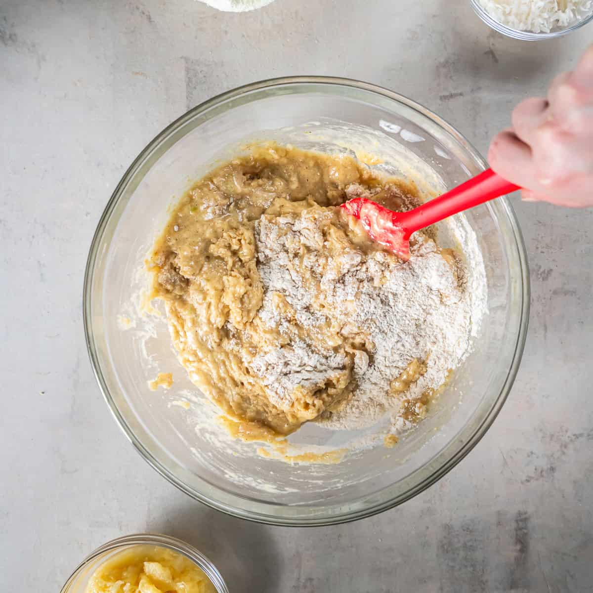 Mixing the wet and dry ingredients together to make Pineapple Zucchini Bread batter.