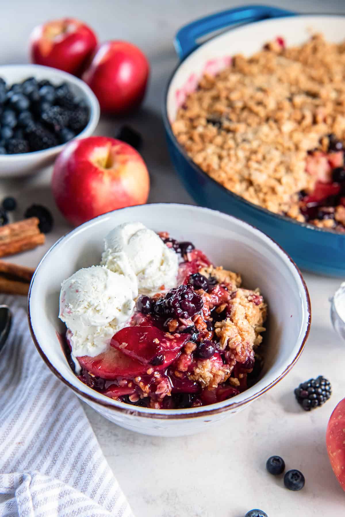Apple Berry Crisp with tender apples, blueberries, blackberries, and golden oat topping served with vanilla ice cream.