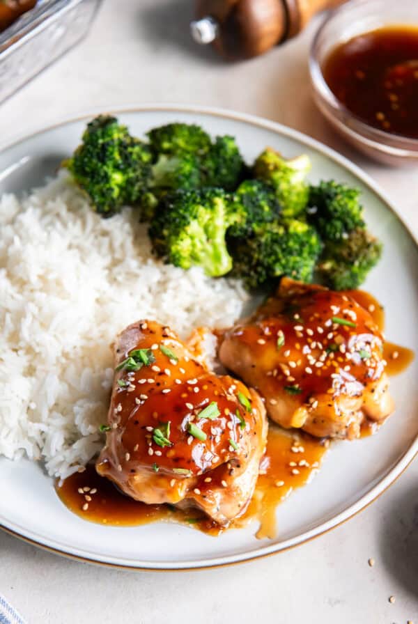 Baked Teriyaki Chicken thighs glazed with homemade teriyaki sauce and served with white rice and broccoli.