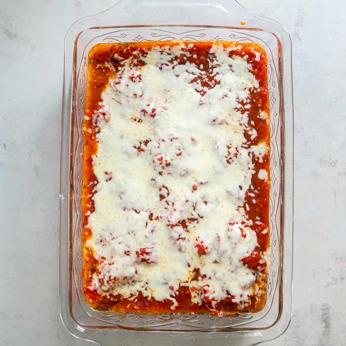 Baked Italian chicken topped with melted mozzarella cheese.