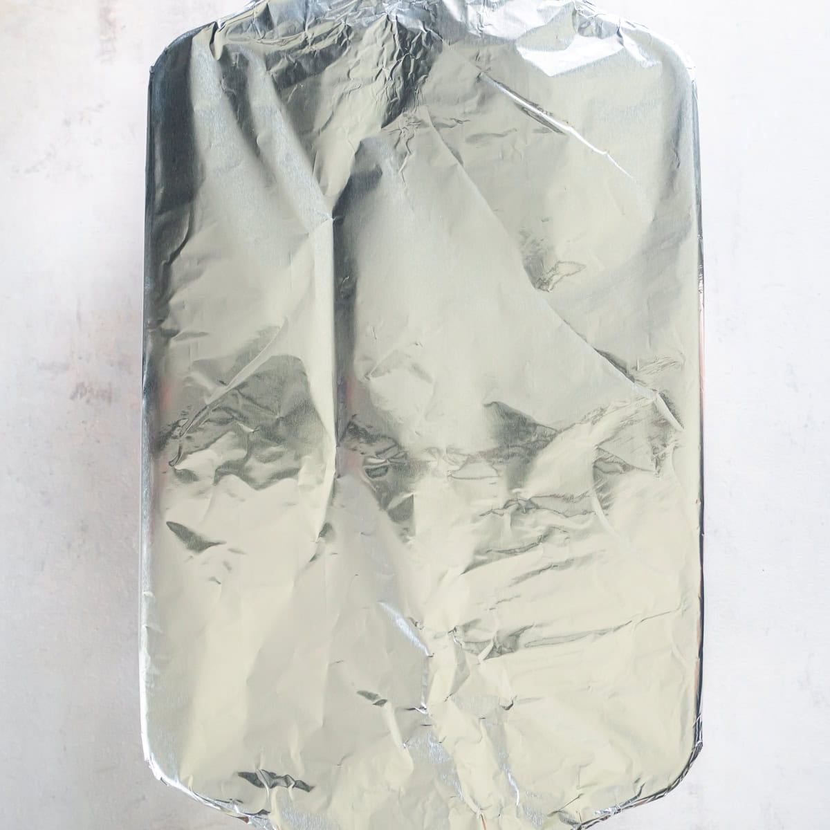 Baking dish covered tightly with aluminum foil before baking.