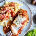 Italian baked chicken served with rotini pasta topped with chunky tomato sauce and grated Parmesan.