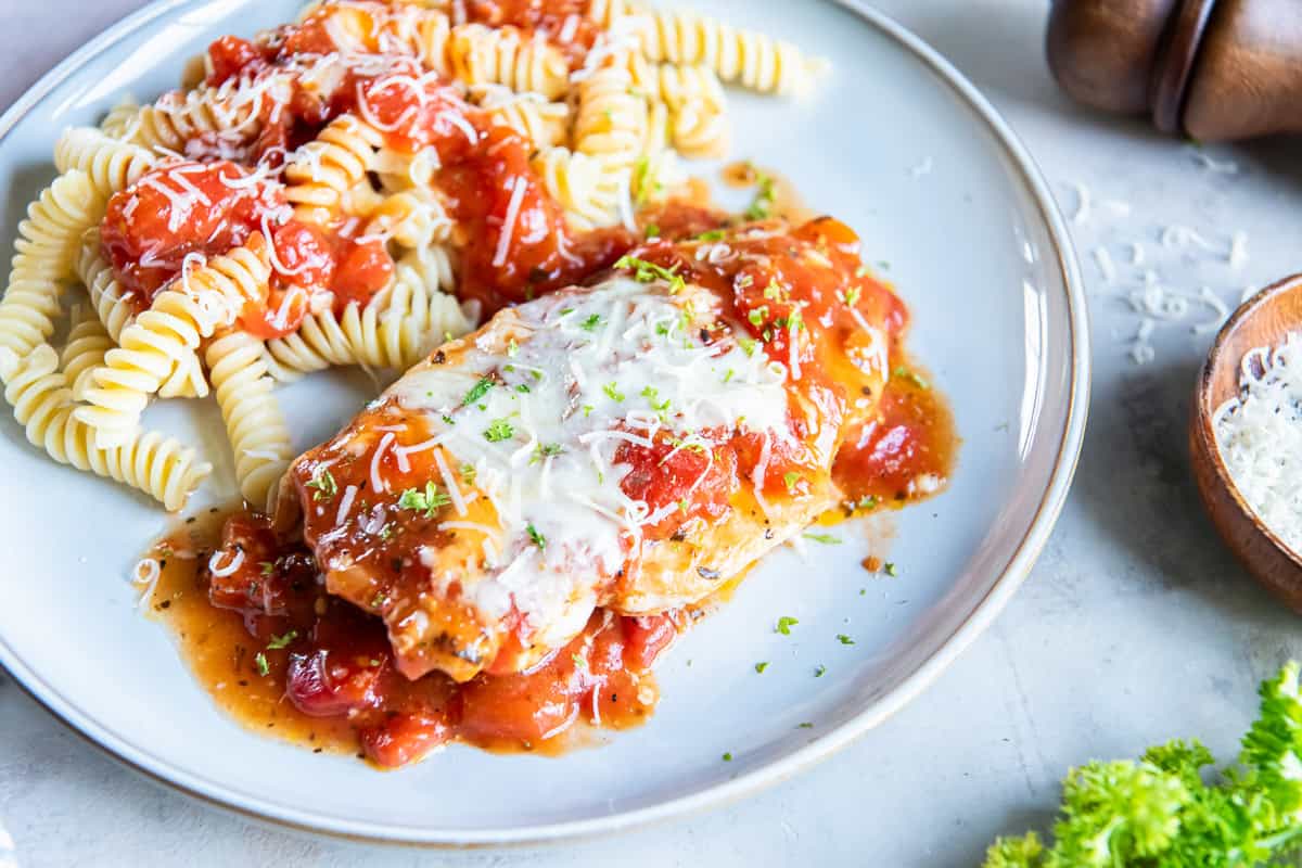 Baked Italian chicken topped with melted mozzarella and chunky tomato sauce served with rotini pasta and grated Parmesan.
