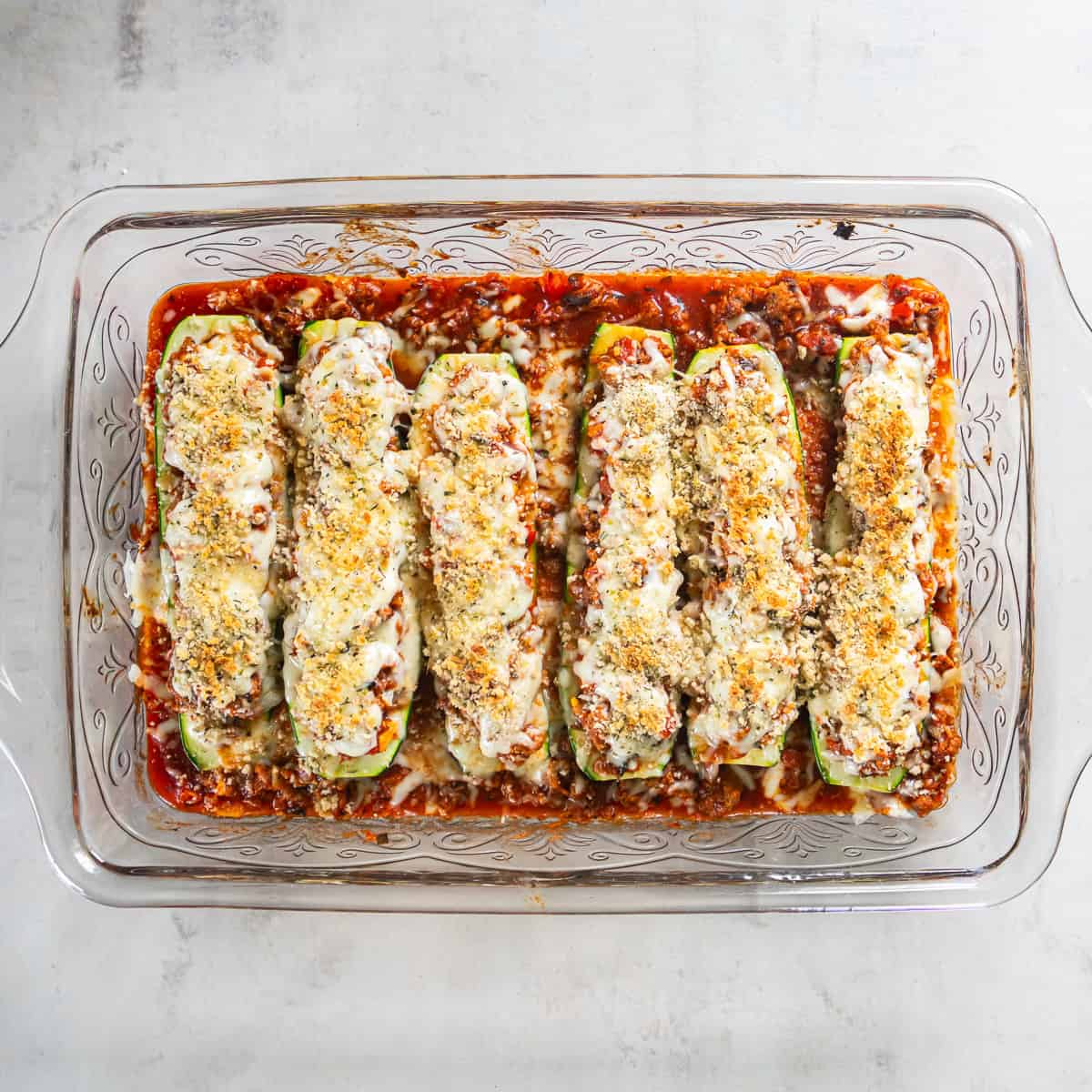 Italian Stuffed Zucchini Boats with melted cheese and golden brown panko topping.