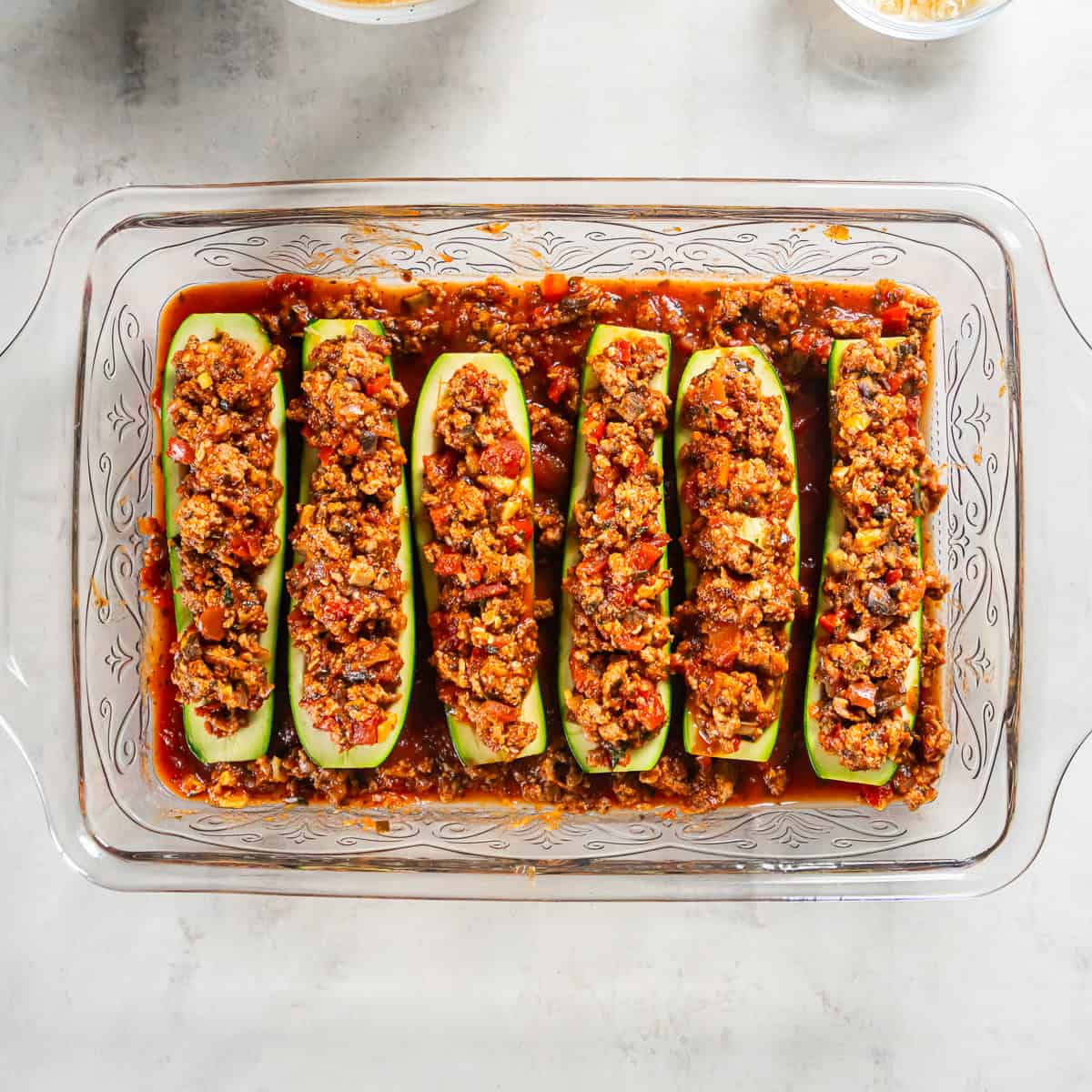 Zucchini boats filled with Italian ground turkey filling and arranged over marinara sauce.