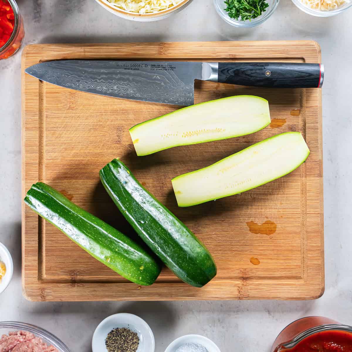 Zucchini sliced in half lengthwise to make Italian Stuffed Zucchini Boats.