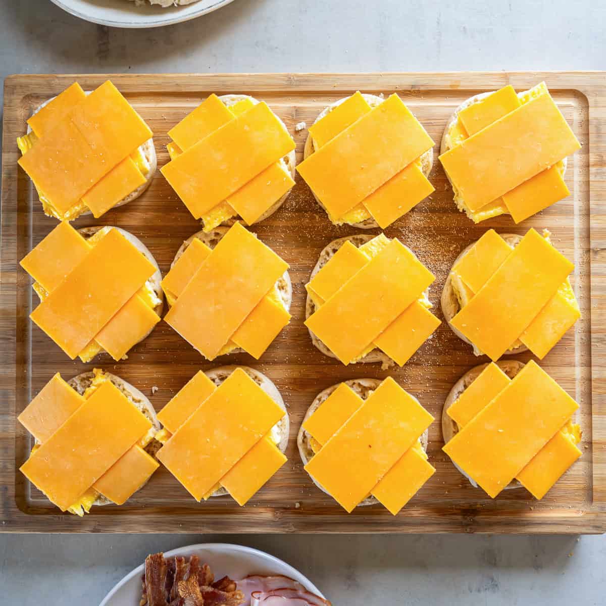 Cheddar cheese halves arranged in a crisscross pattern over the egg squares.