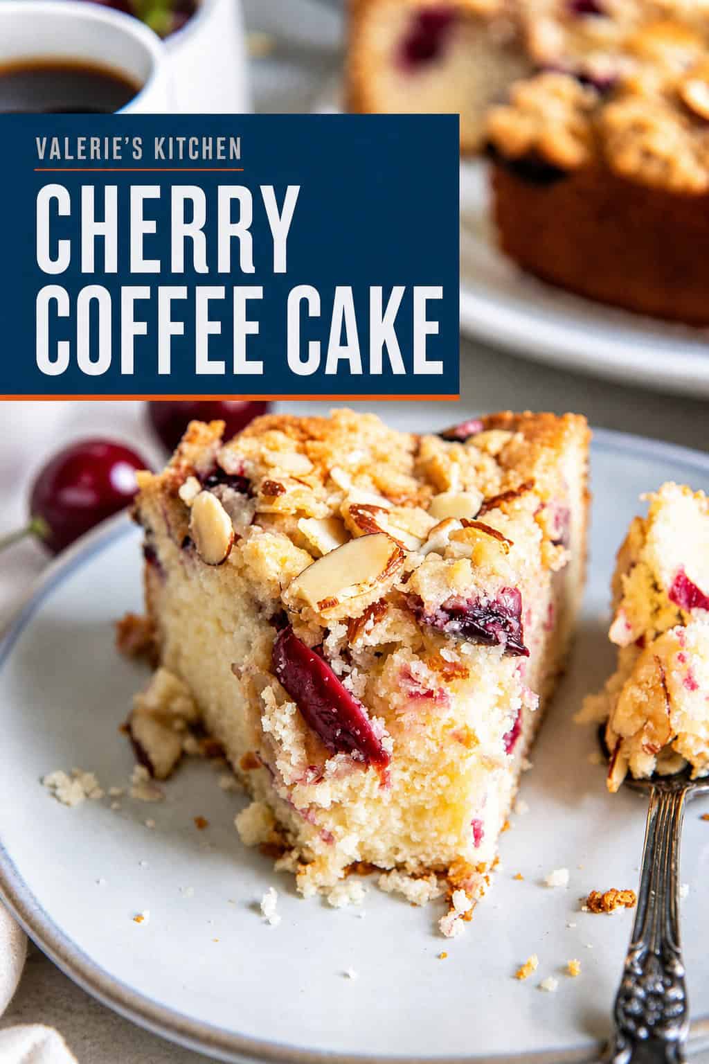Slice of cherry coffee cake with fresh cherries and an almond streusel topping served with coffee with bold text overlay.