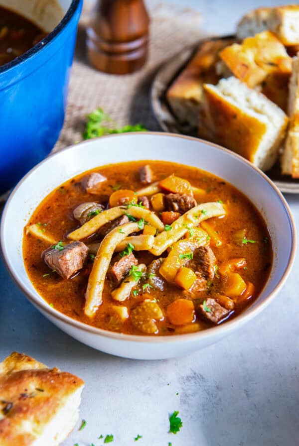 Old-fashioned beef noodle soup with tender beef, thick egg noodles, carrots, celery, and parsley in a rich beef broth.