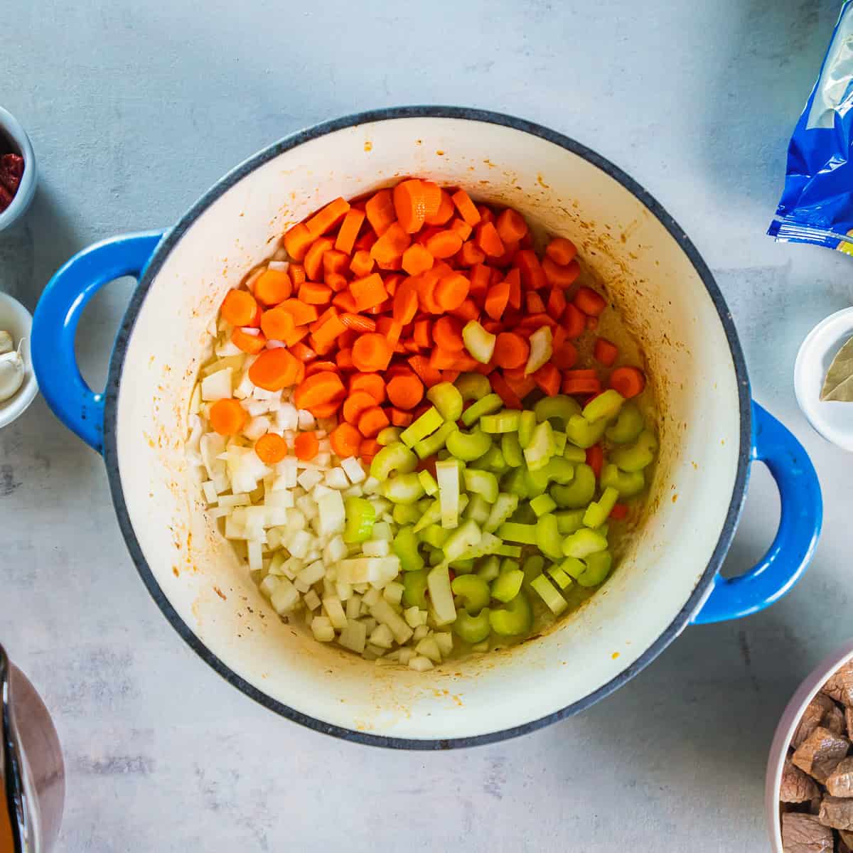 Chopped carrots, celery, and onion added to the Dutch oven.