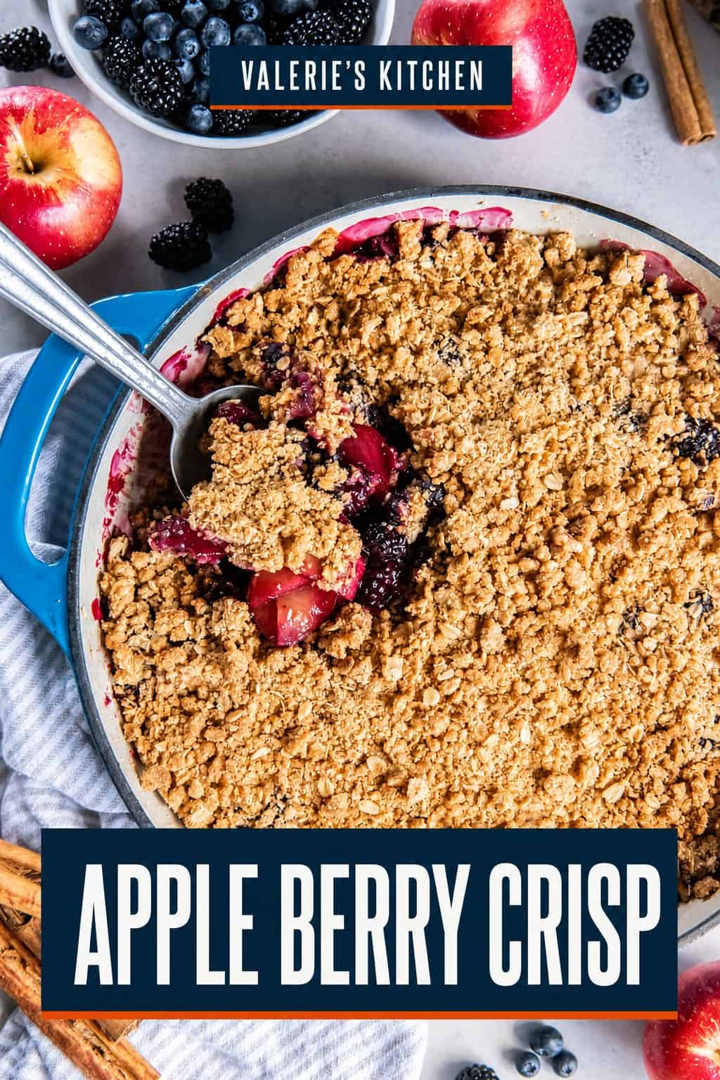 Apple Berry Crisp with a spoonful lifted from the baking dish, showing tender apples, berries, and a golden oat topping with bold title text overlay.