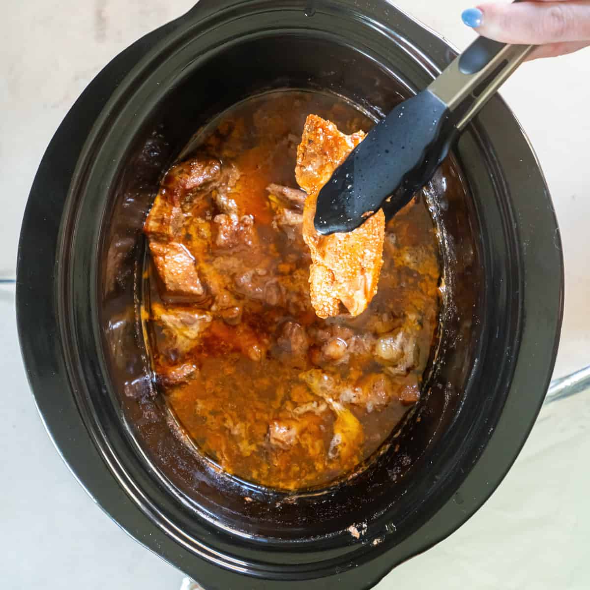 Remove the tender ribs from the slow cooker.