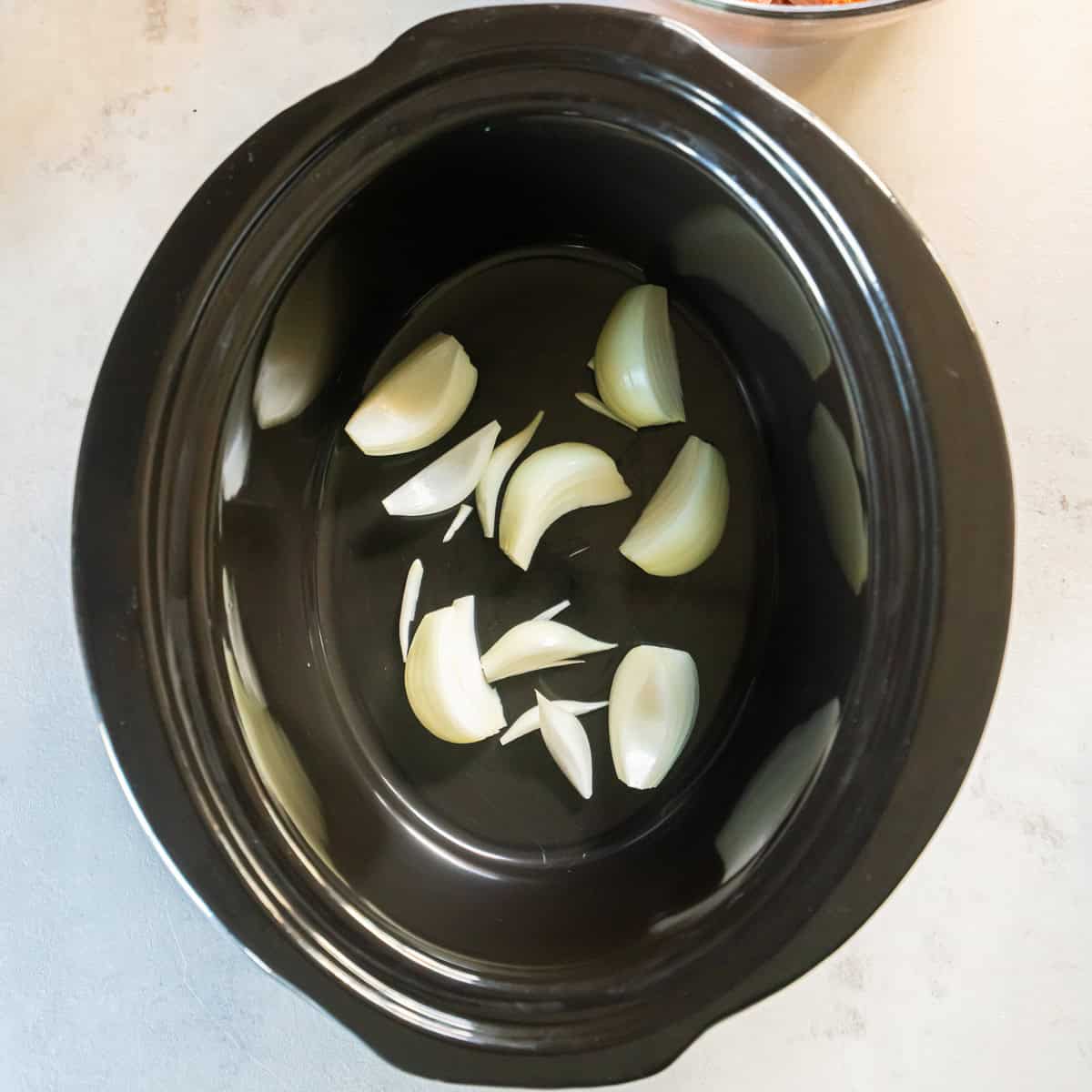 Place the onion chunks in the slow cooker.