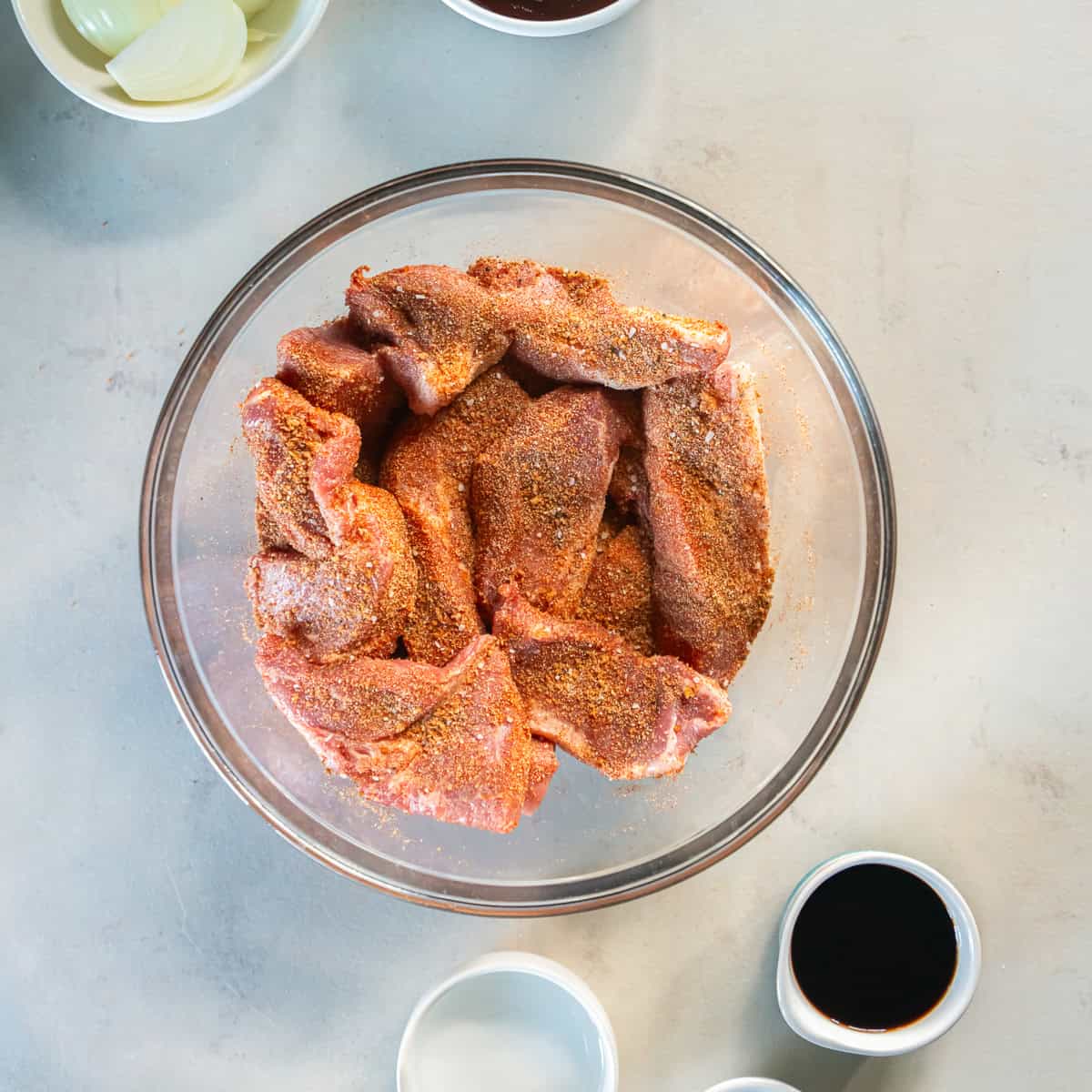 Season the ribs with the smoky spice rub.