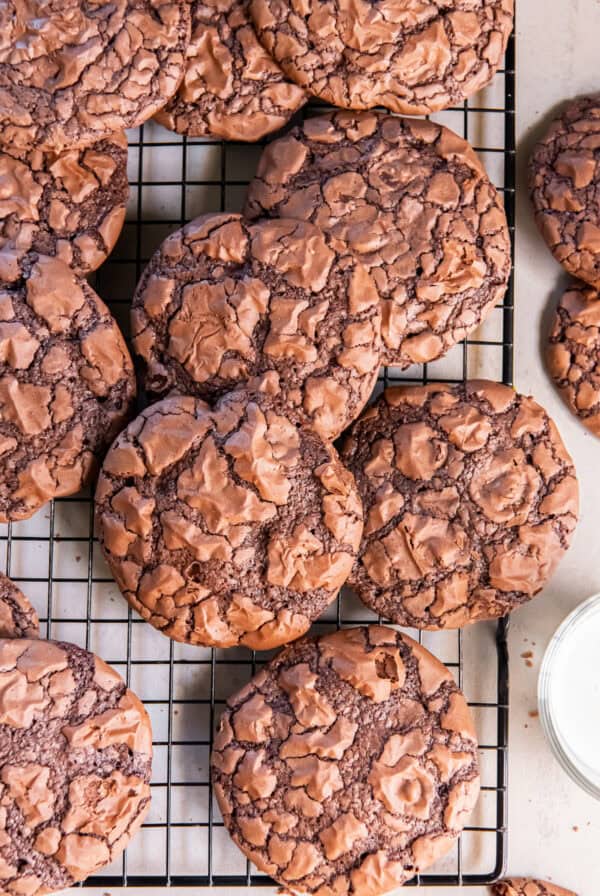 Brownie mix cookies with shiny, crackly tops arranged on a wire cooling rack.