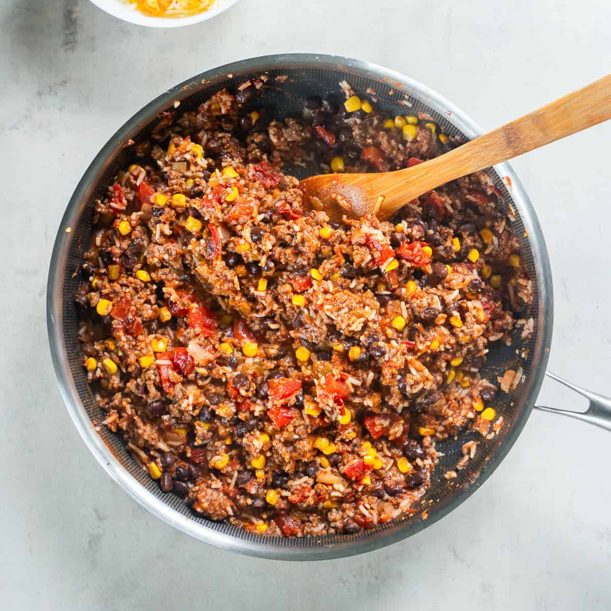 Mexican stuffed pepper filling with seasoned ground beef, rice, black beans, corn, and tomatoes.