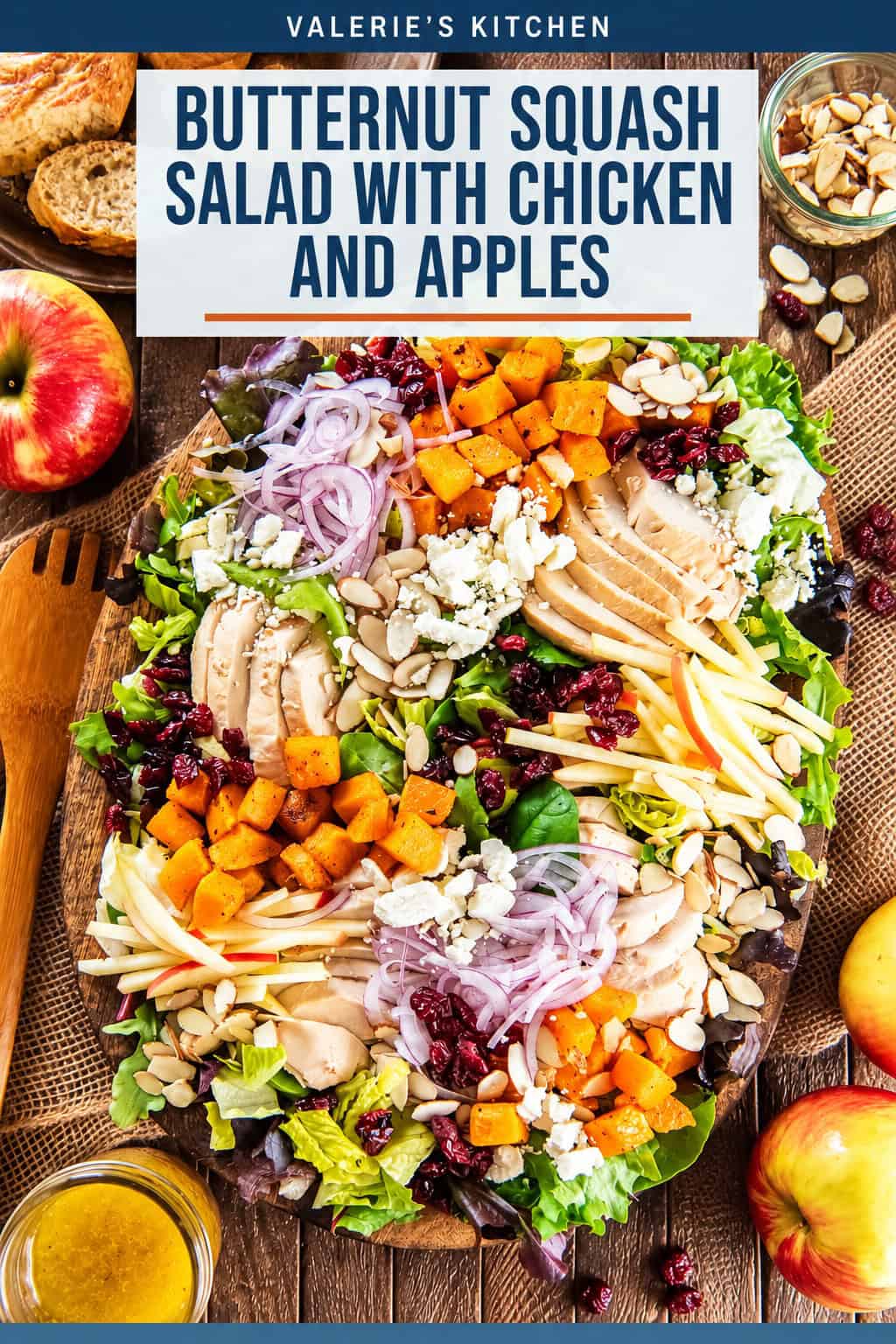 Roasted butternut squash salad with chicken, crisp apples, dried cranberries, sliced almonds, feta cheese, and red onion on a bed of mixed greens, served with maple Dijon vinaigrette with bold title text overlay.