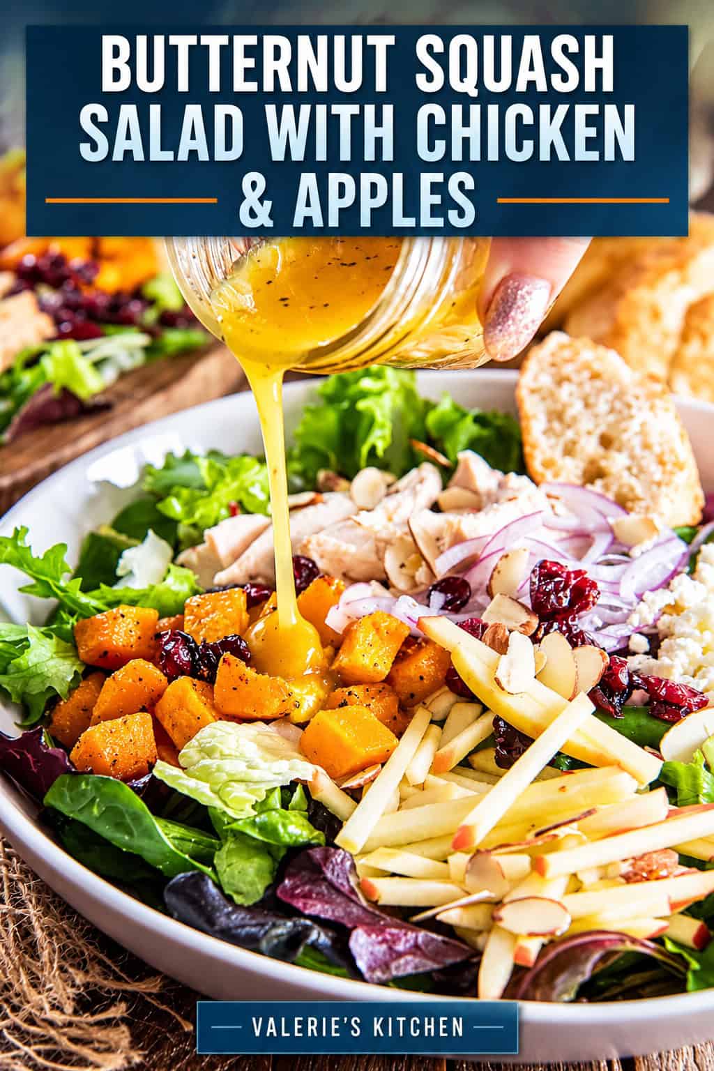 A hand pours maple vinaigrette over a bowl of butternut squash salad with chicken and apples with bold title text overlay.