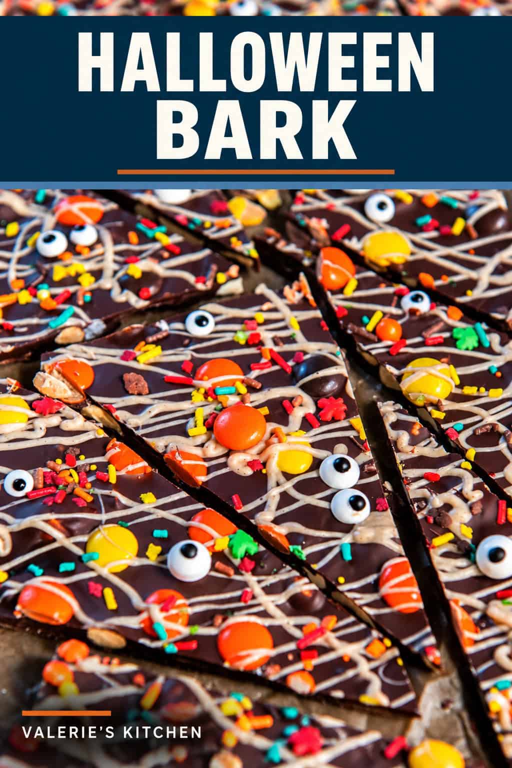 Close-up of Halloween chocolate bark pieces topped with pumpkin spice white chocolate drizzle, Reese’s Pieces, colorful sprinkles, and candy eyeballs with bold title text overlay.