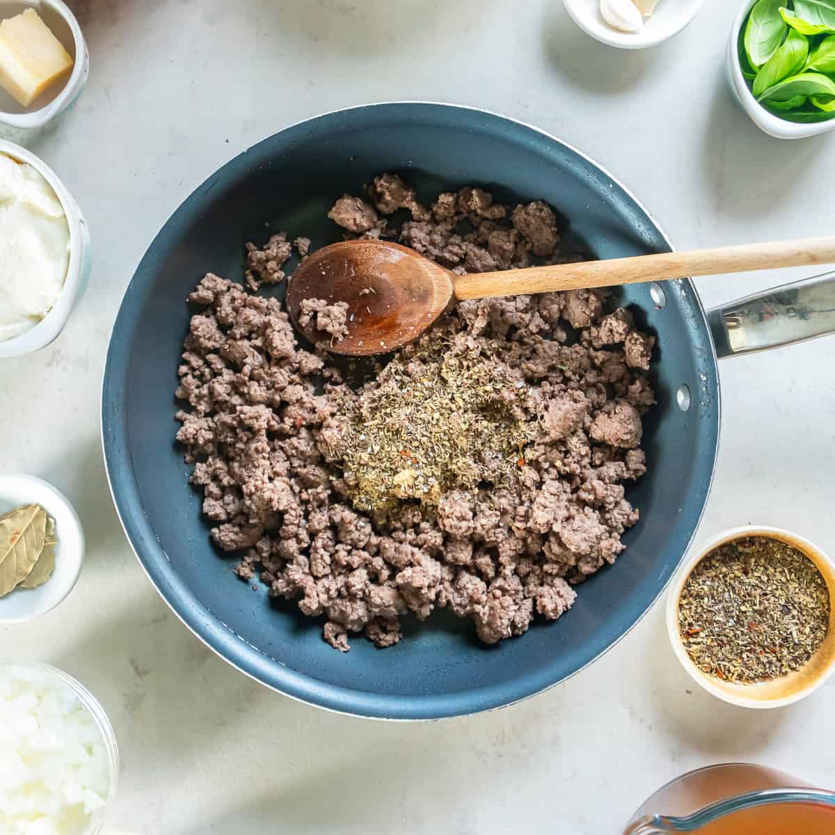 Cooked ground beef in a skillet with spices.